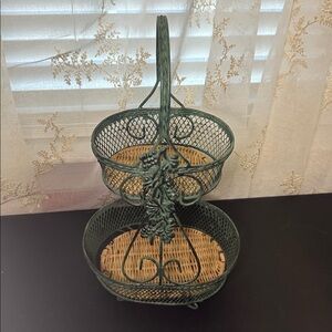 Wire Basket stand made of green-painted metal wire with a woven wicker base